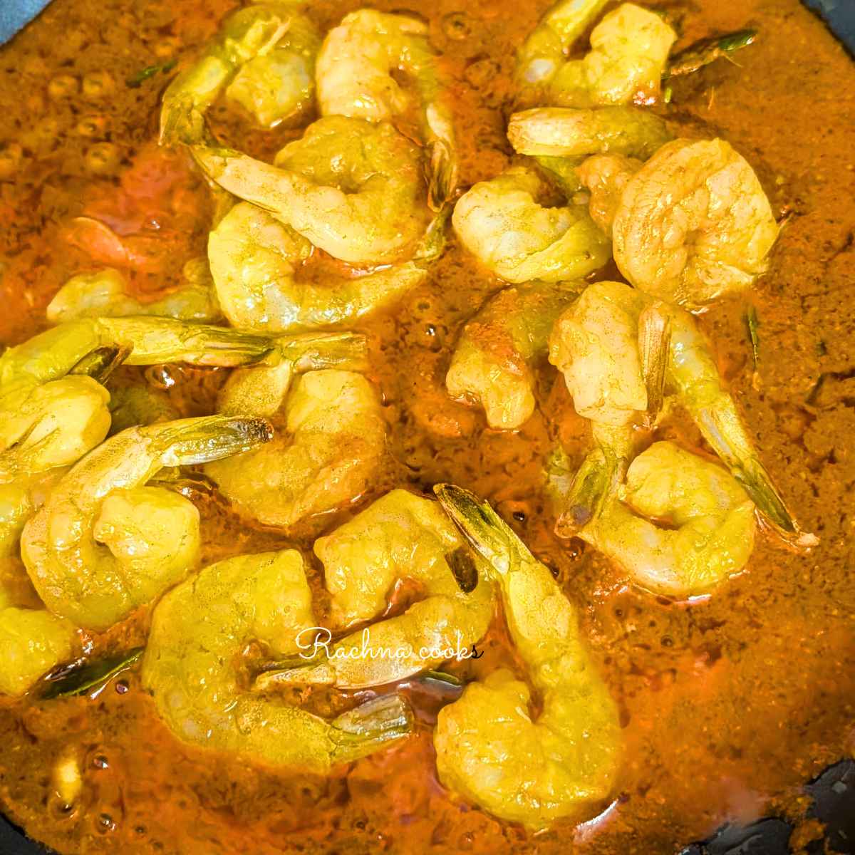 Prawns added to ghee roast masala in a pan