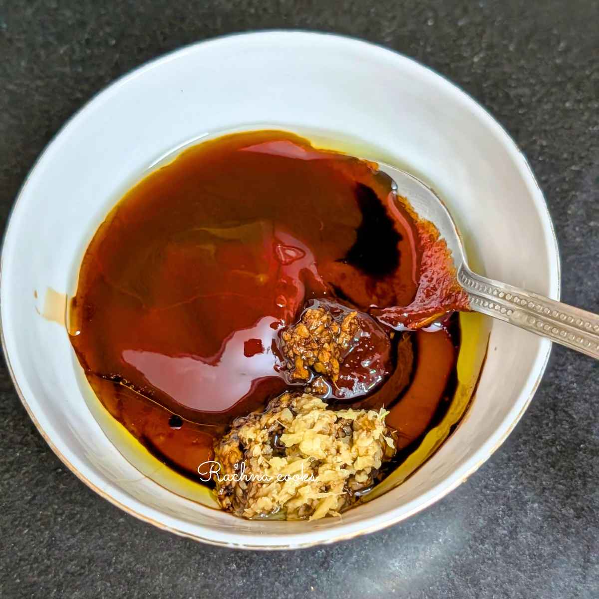 Gochujang sauce ingredients being mixed in a white bowl