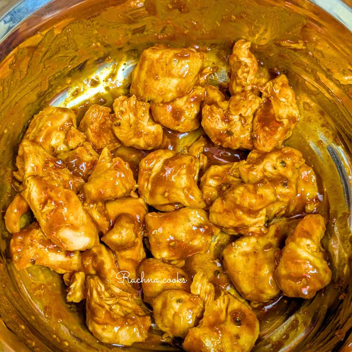 Air fried chicken bites tossed with gochujang sauce in a bowl