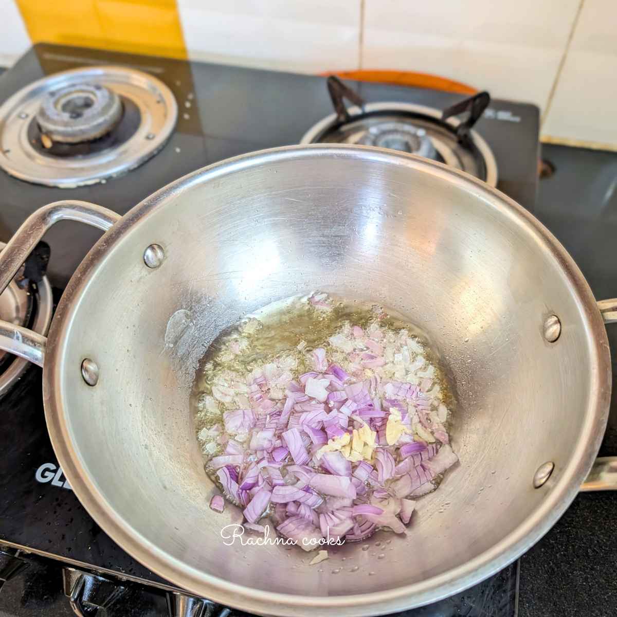 Chopped onion and garlic adding to sizzling oil in a wok