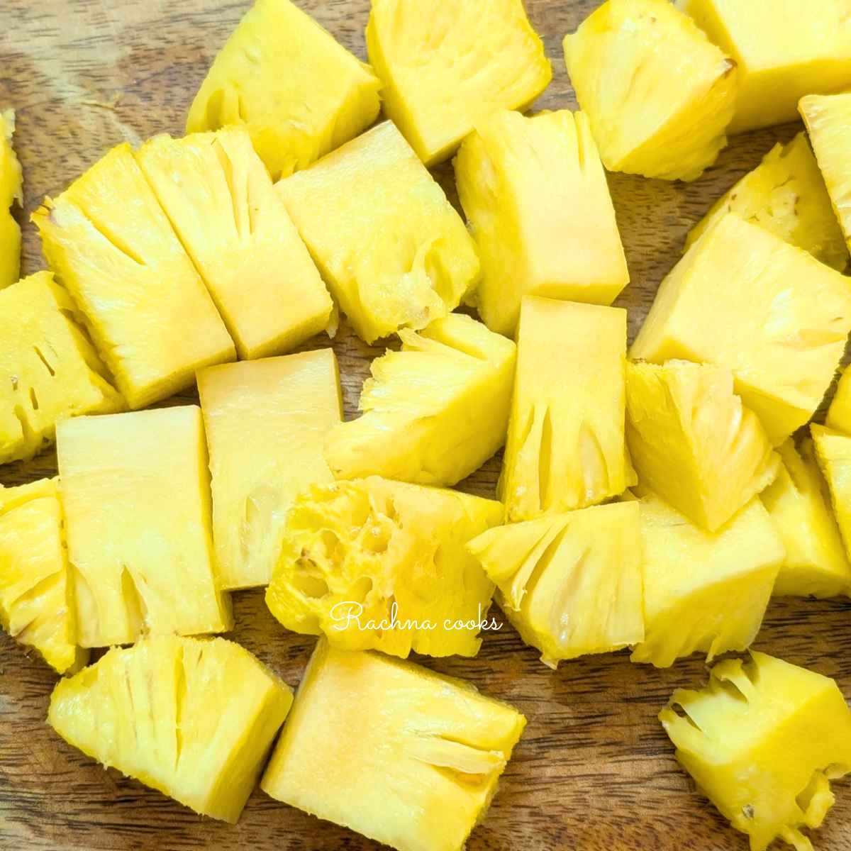 Cut pineapple chunks on a chopping board